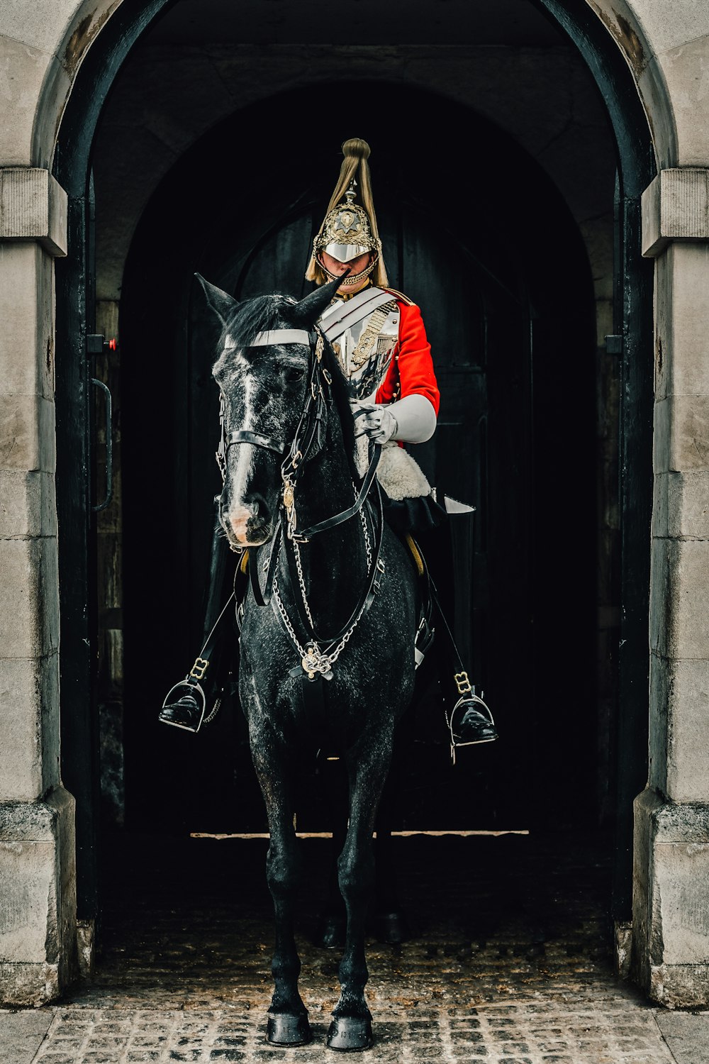 a man in a uniform riding a horse