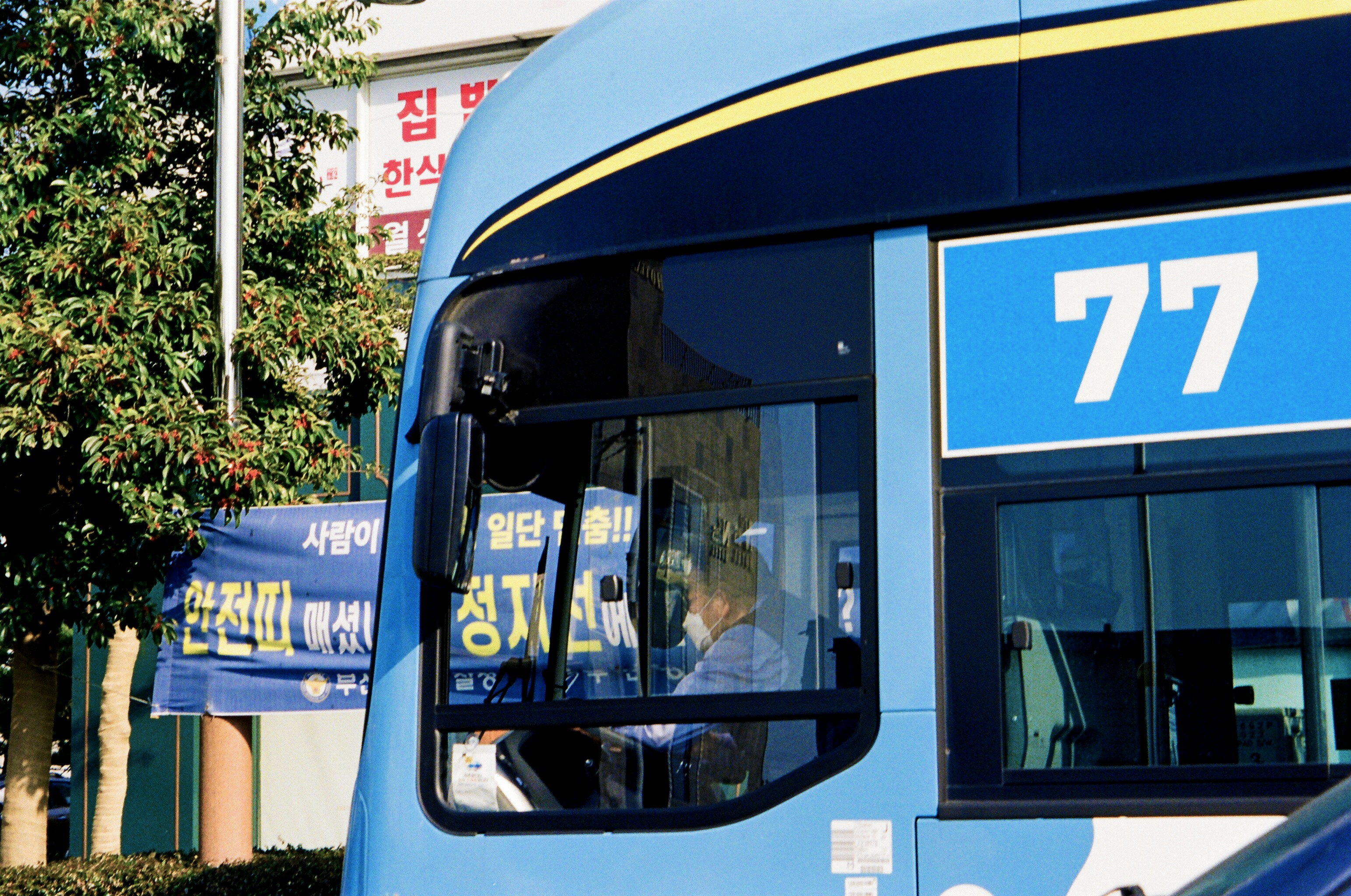 a blue double decker bus parked in front of a building