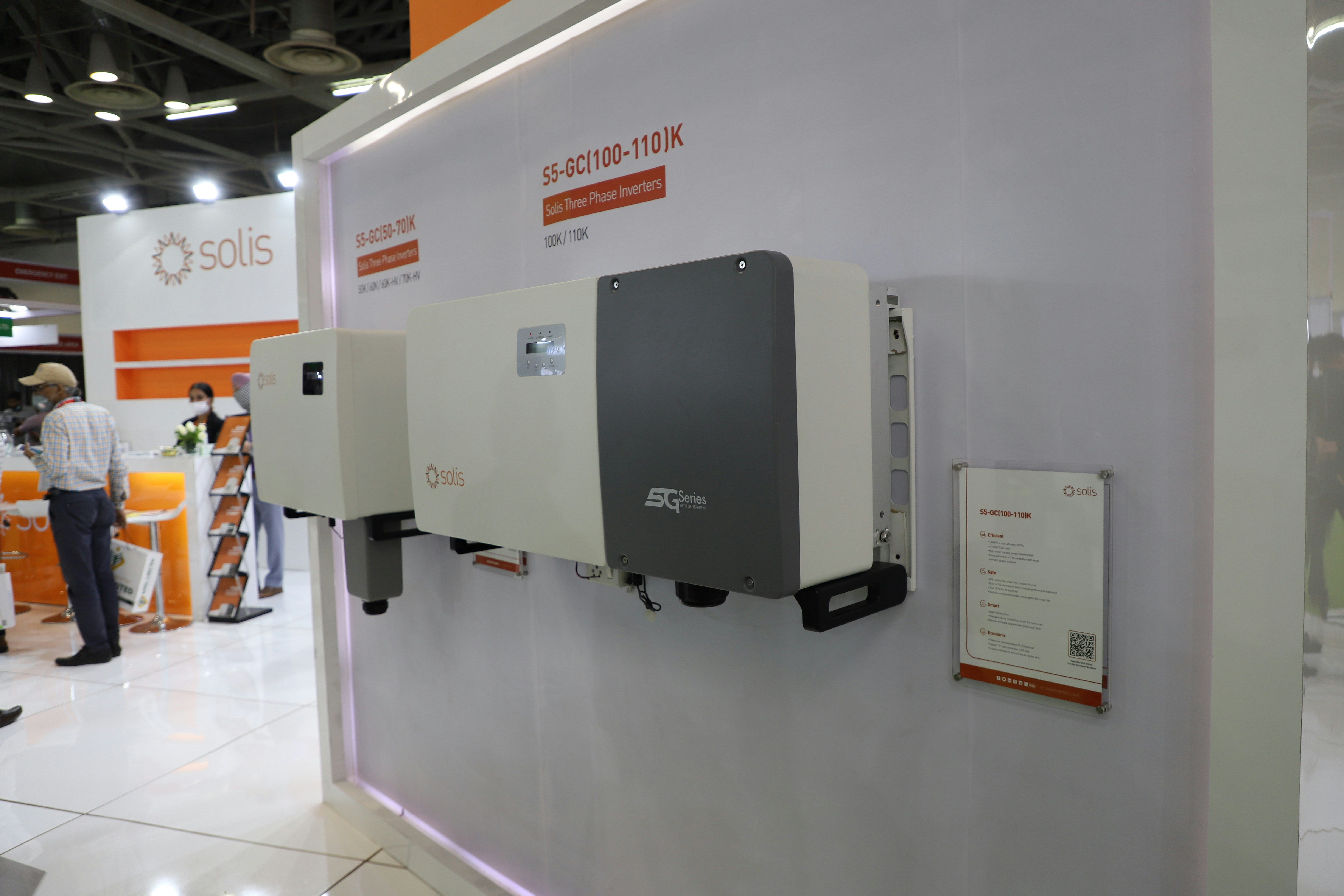 Solar inverter mounted on a clean bright white wall in a technical installation