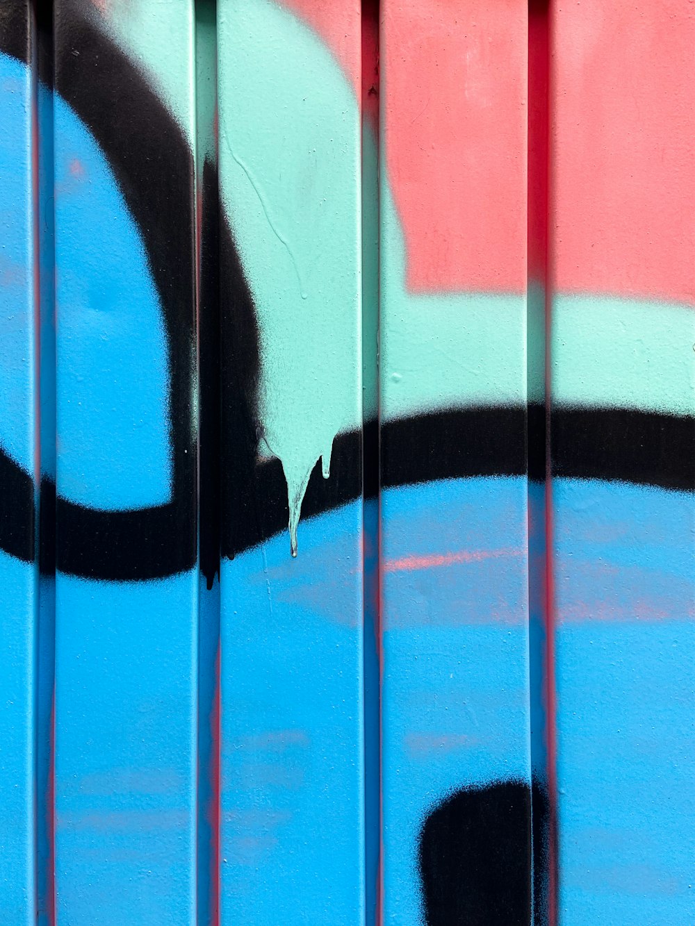 a close up of a wall with graffiti on it