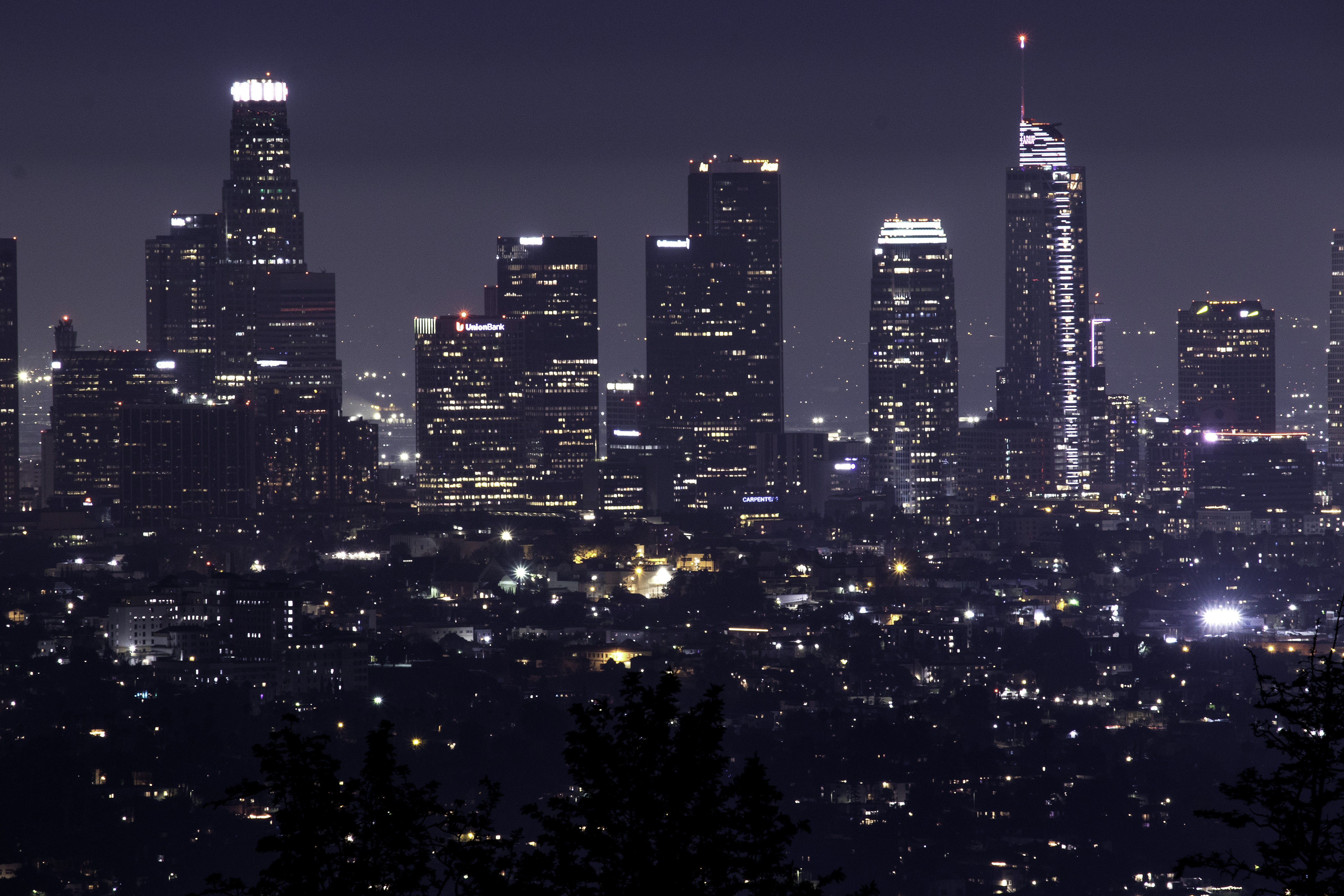 a city skyline at night with the lights on