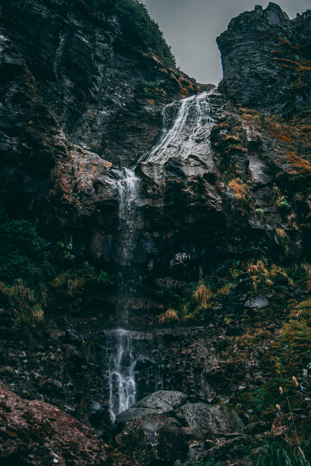 a waterfall in the middle of a rocky area