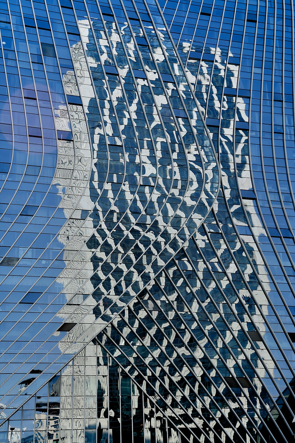 the reflection of a building in the windows of another building