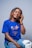 a woman with dreadlocks sitting down and talking on a cell phone