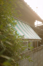 Modern retractable awning installed on a residential patio with sunlight filtering through.