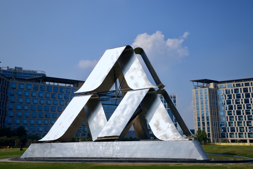 a large metal sculpture in front of a building
