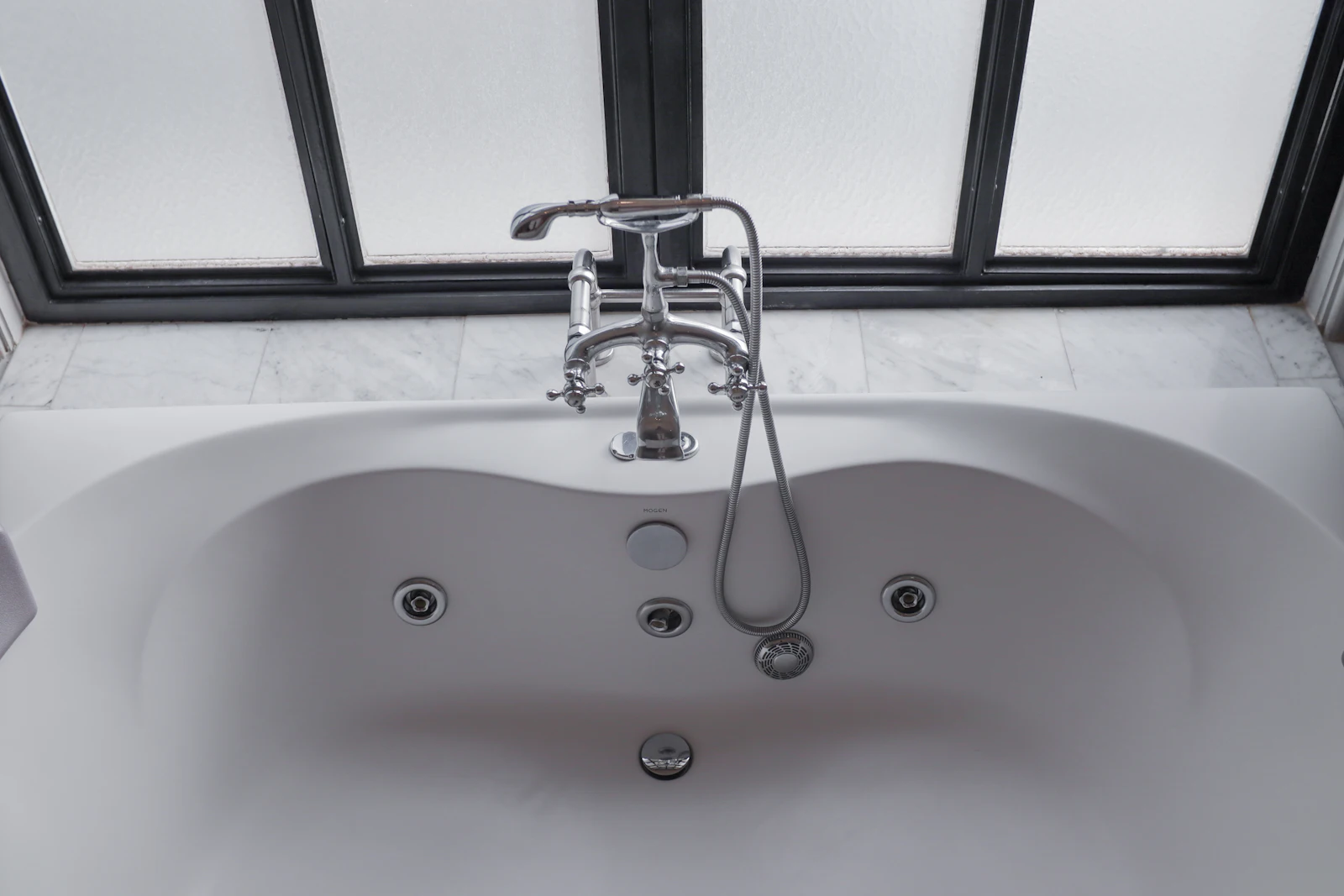 Bathtub with jets and a chrome faucet