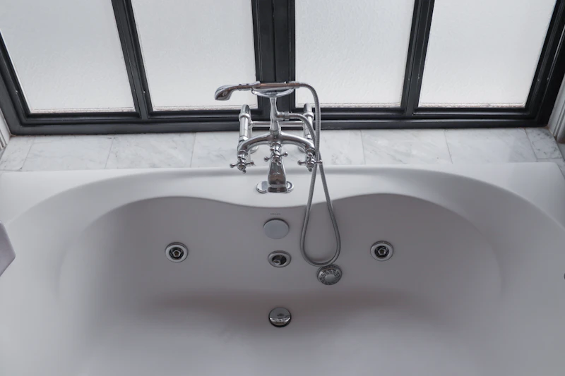 Non Slip Bath Mat in Clovis — White bathtub beside a sunlit window