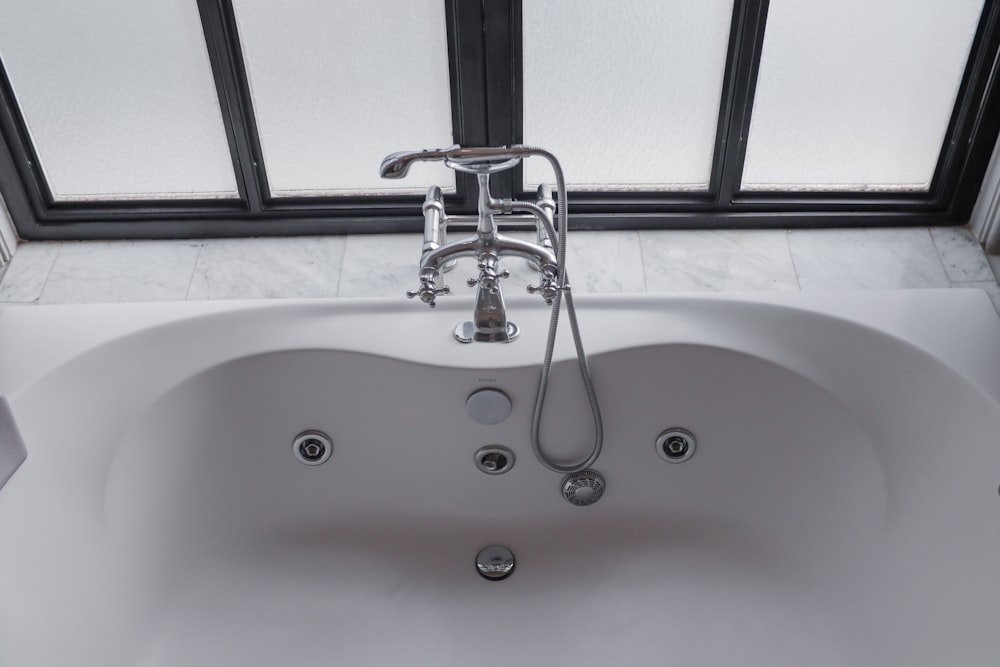 a white bath tub sitting next to a window