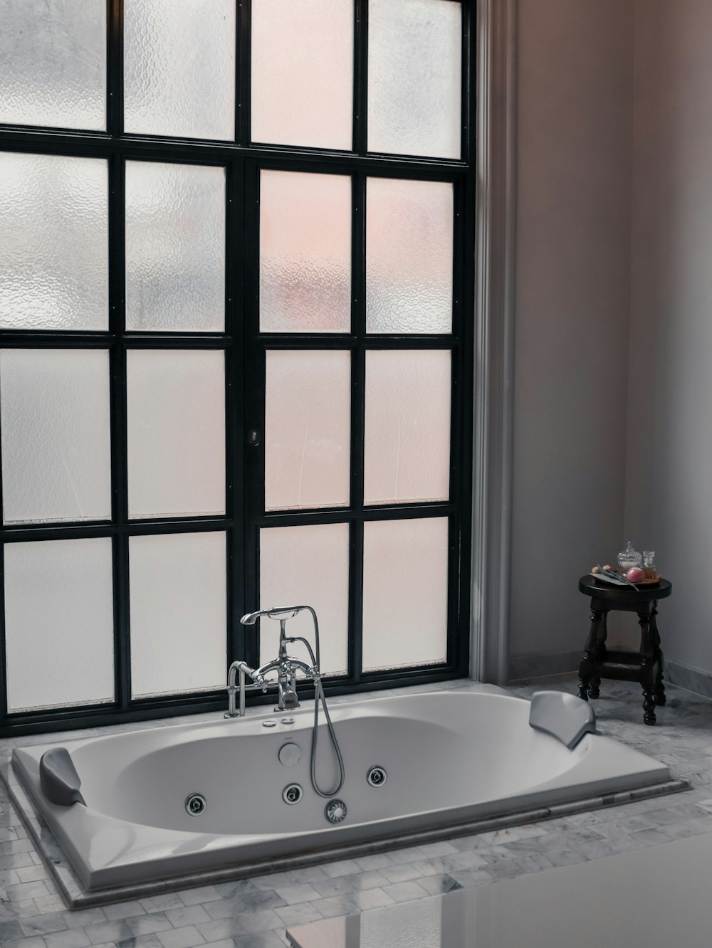 a bath tub sitting next to a window in a bathroom