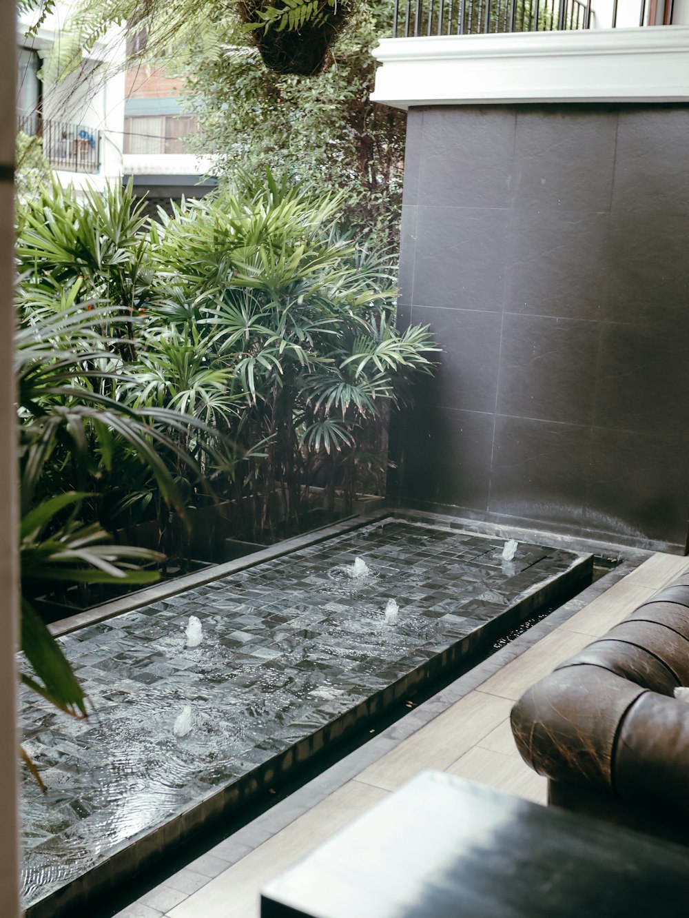 a living room with a couch and a water feature