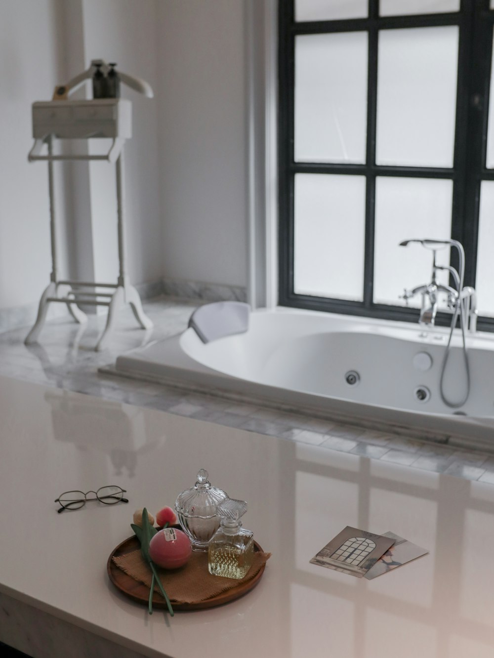 a bathroom with a bathtub and a tray of fruit on the counter