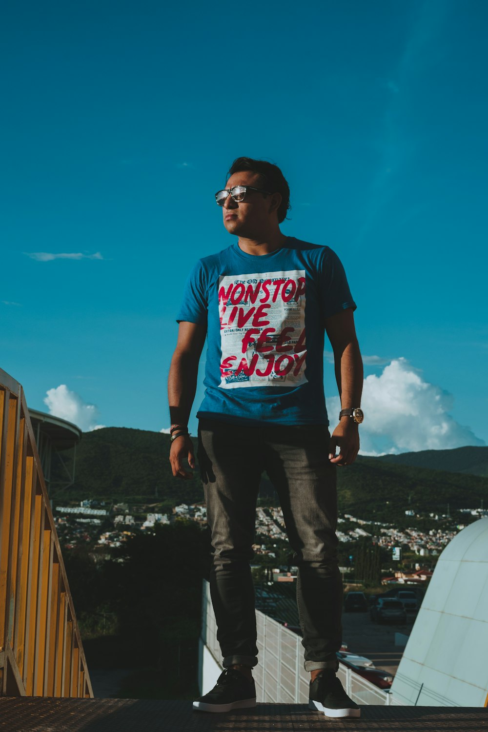 a man standing on top of a roof