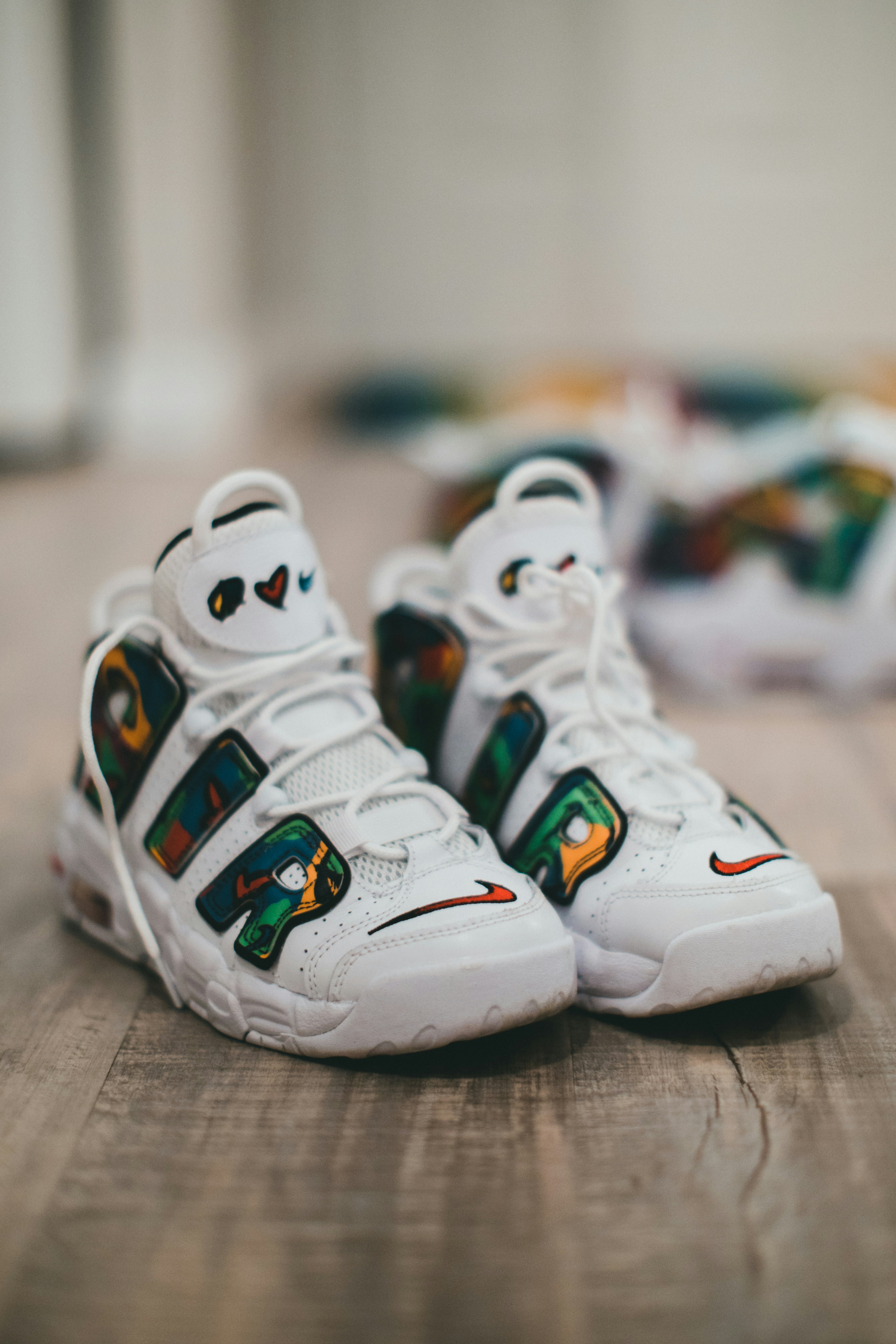 Colorful African Ankara print sneakers on wooden floor