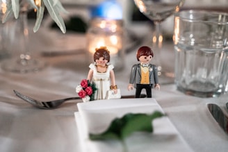 a couple of figurines sitting on top of a table