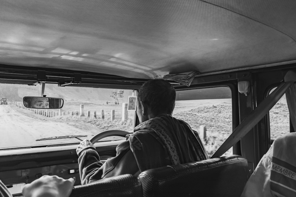 a group of people sitting around a car