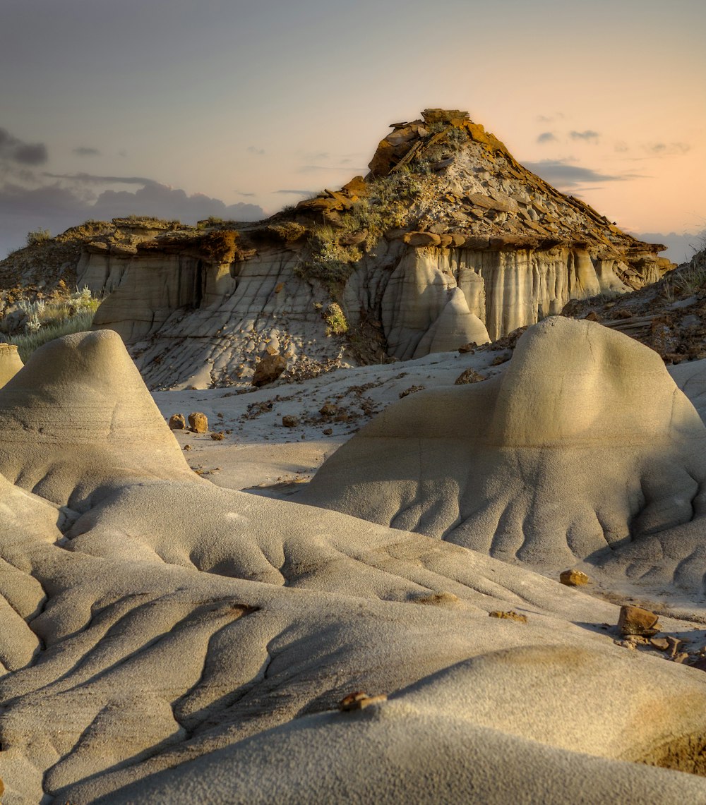 a desert landscape with a mountain in the background