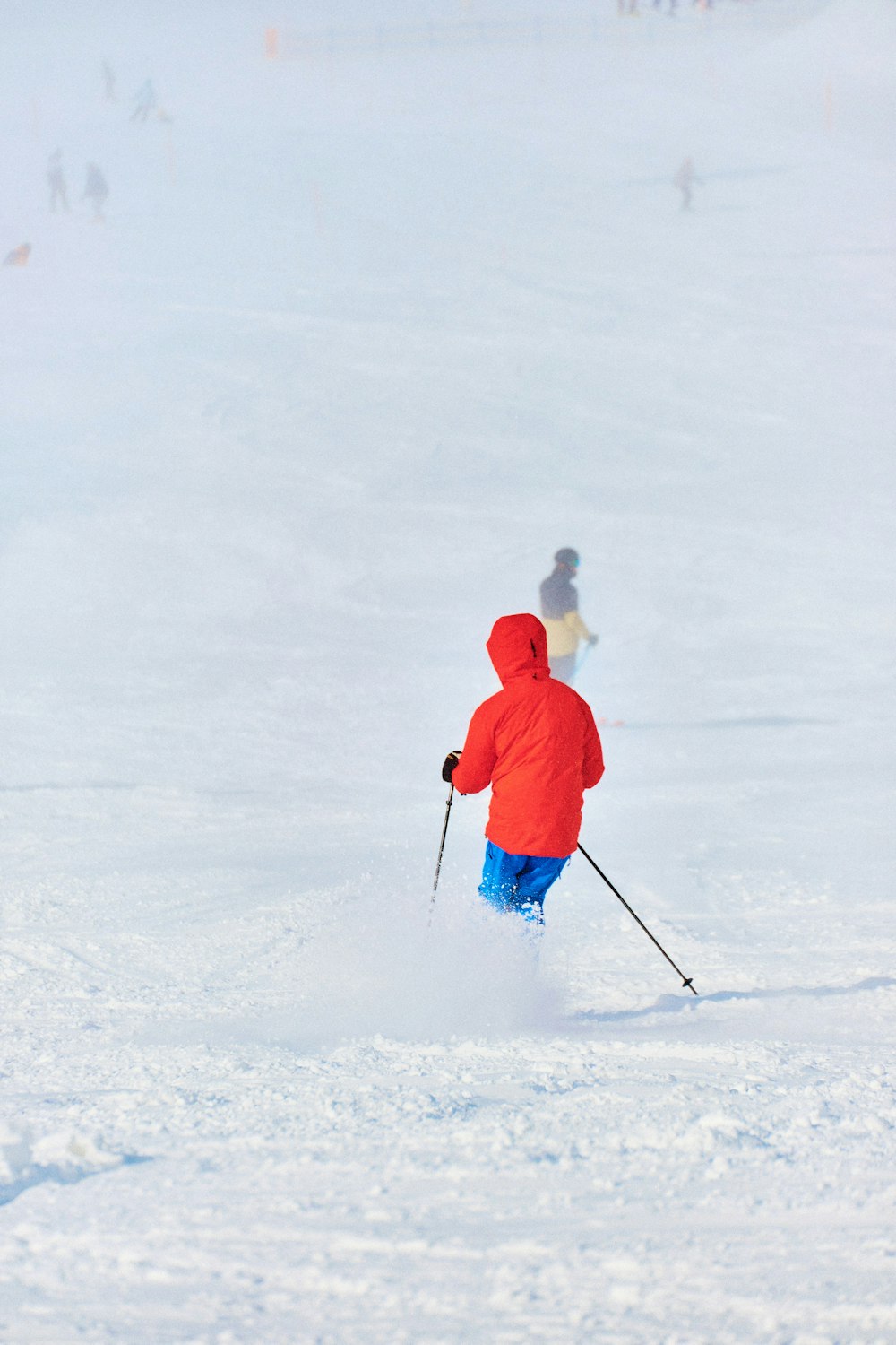 a person riding skis down a snow covered slope