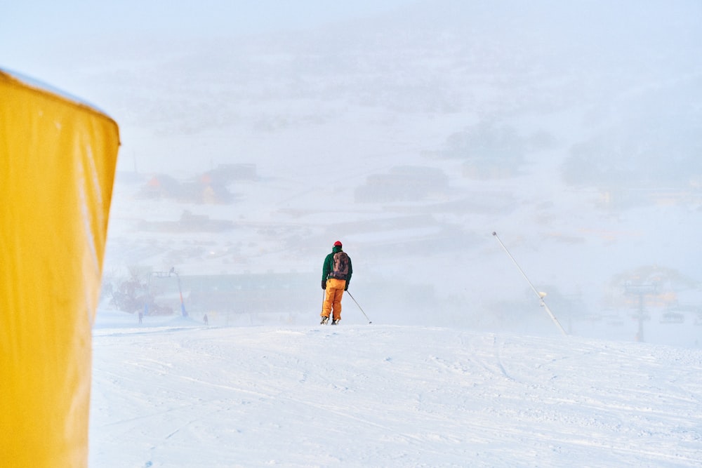 a man riding skis on top of a snow covered slope