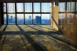 Bright room with large windows overlooking the city skyline.