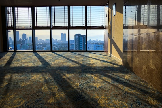 A bright, stylish loft apartment with large windows overlooking the city skyline.