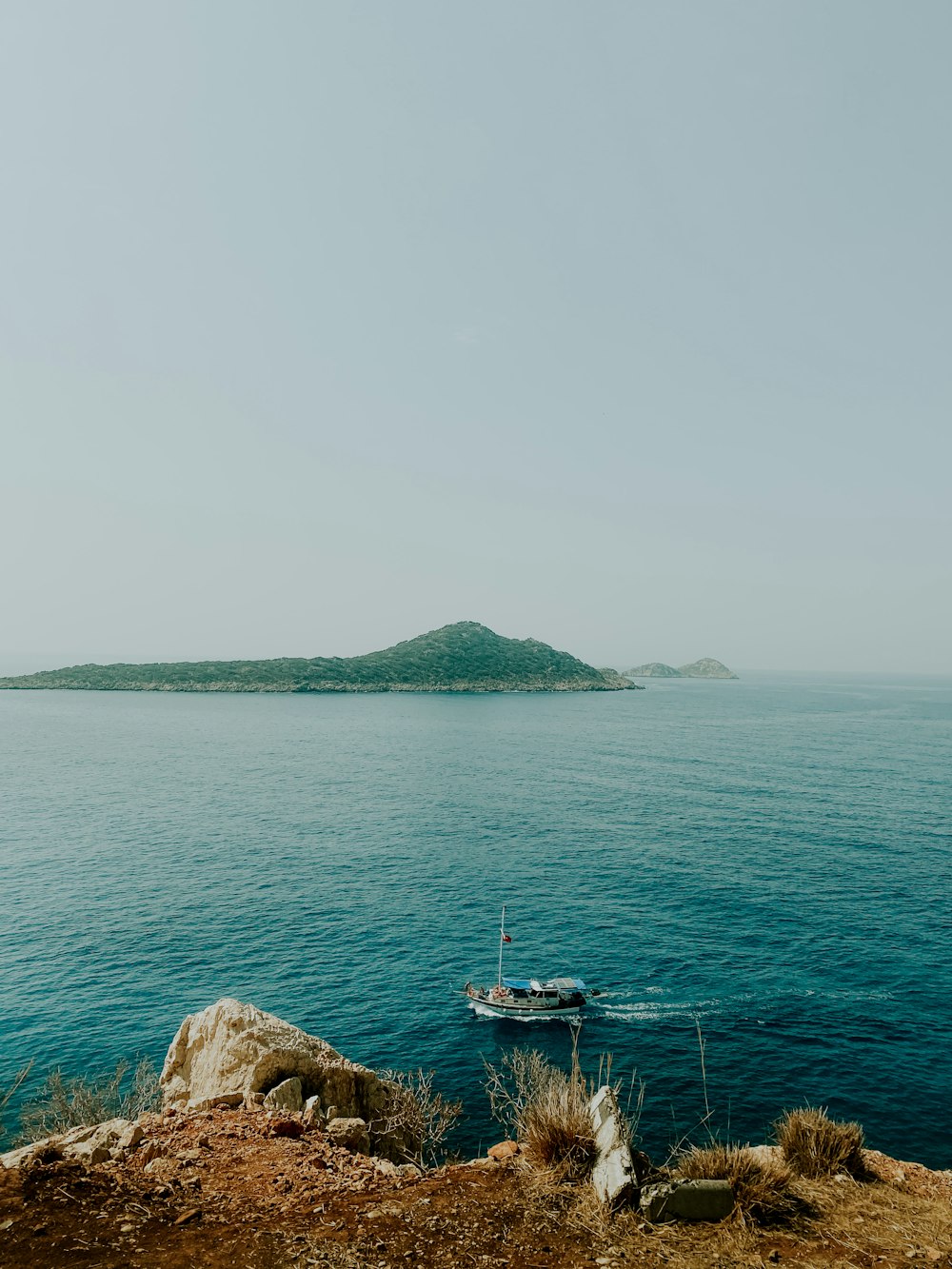 a boat floating on top of a large body of water