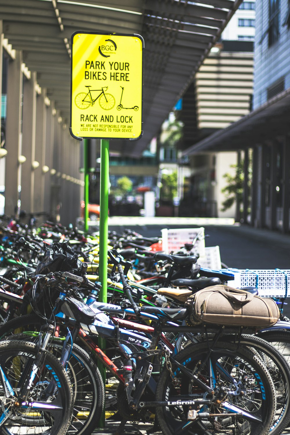 a parking lot full of bikes with a yellow sign