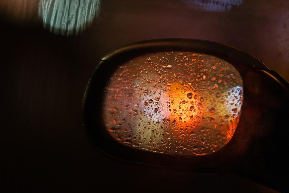 a rear view mirror with rain drops on it
