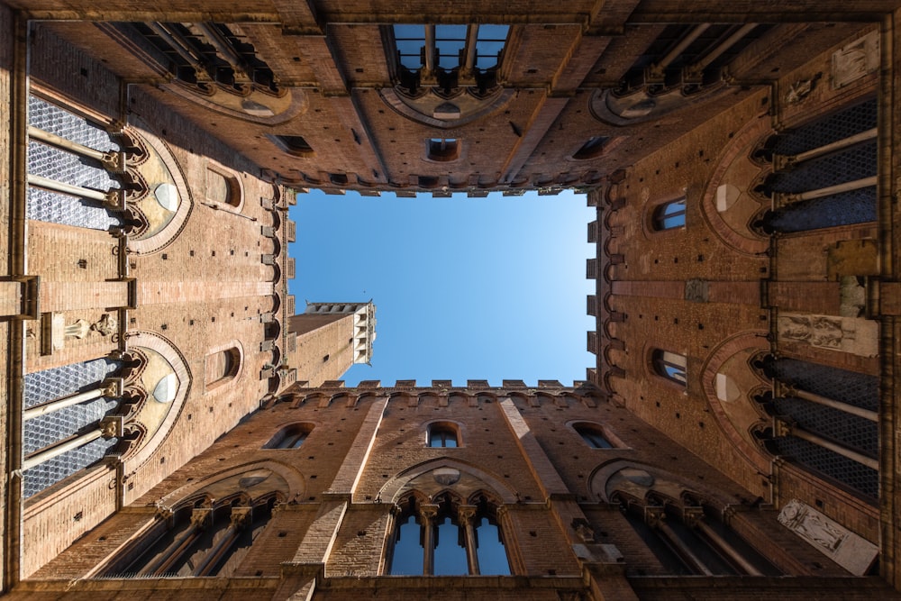 a very tall building with a sky view looking up