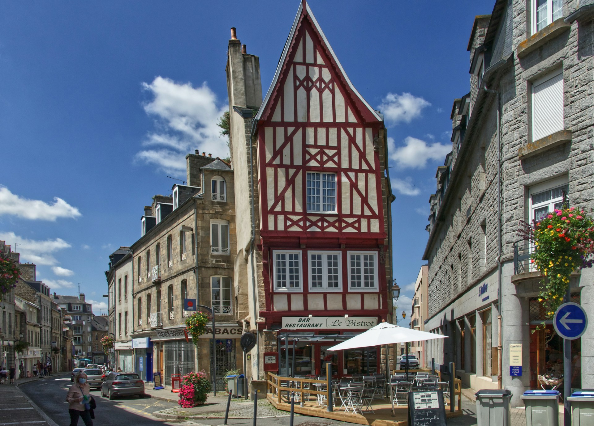 a tall red and white building sitting on the side of a road