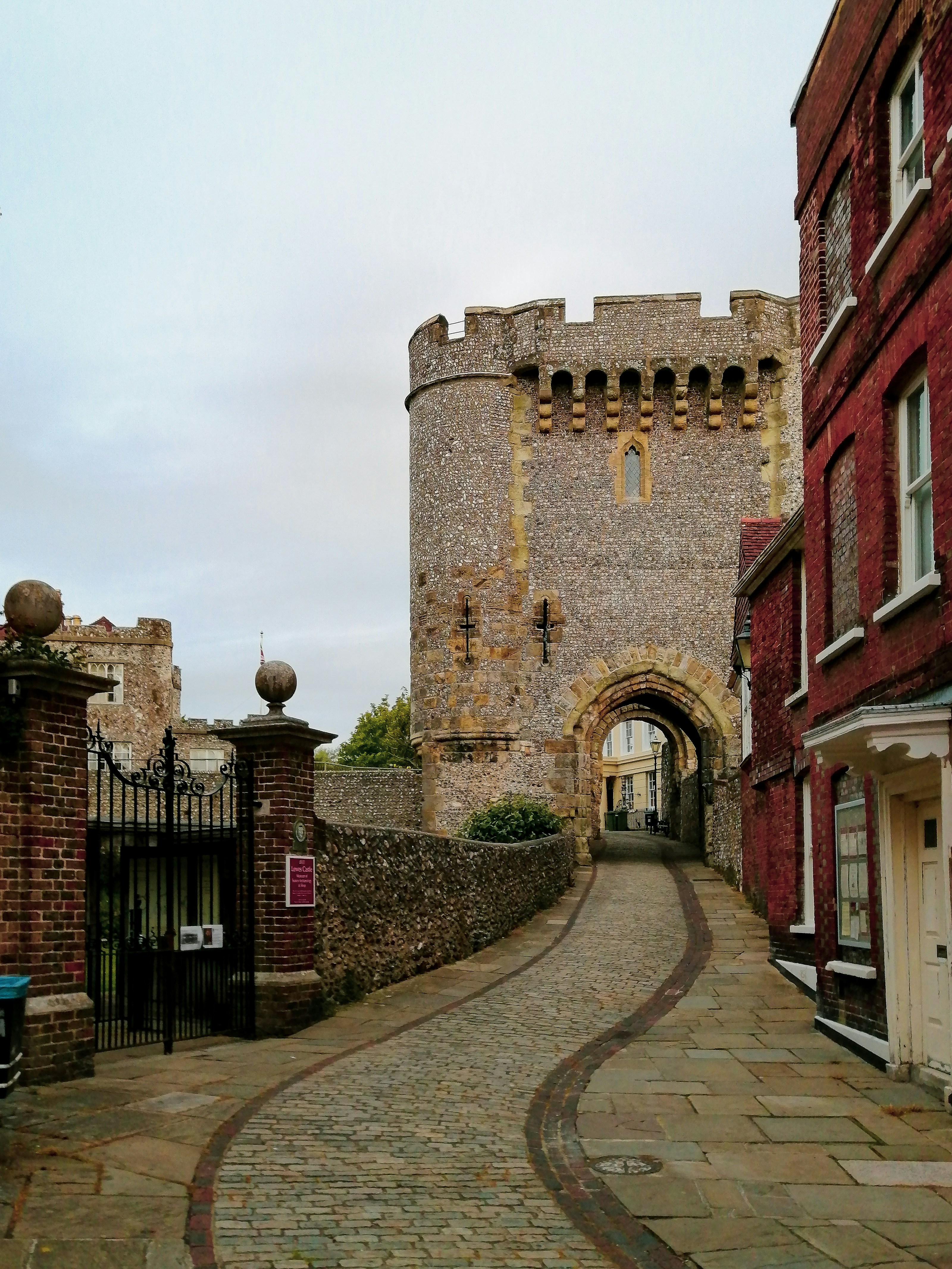 a cobblestone street leading to a castle like building