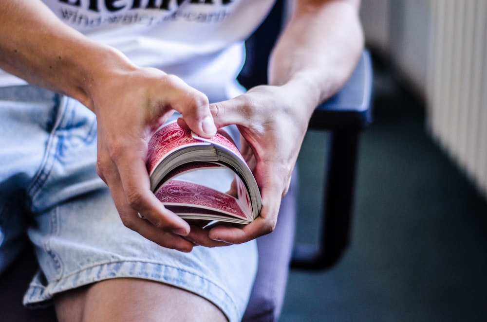 a person sitting on a chair holding a book