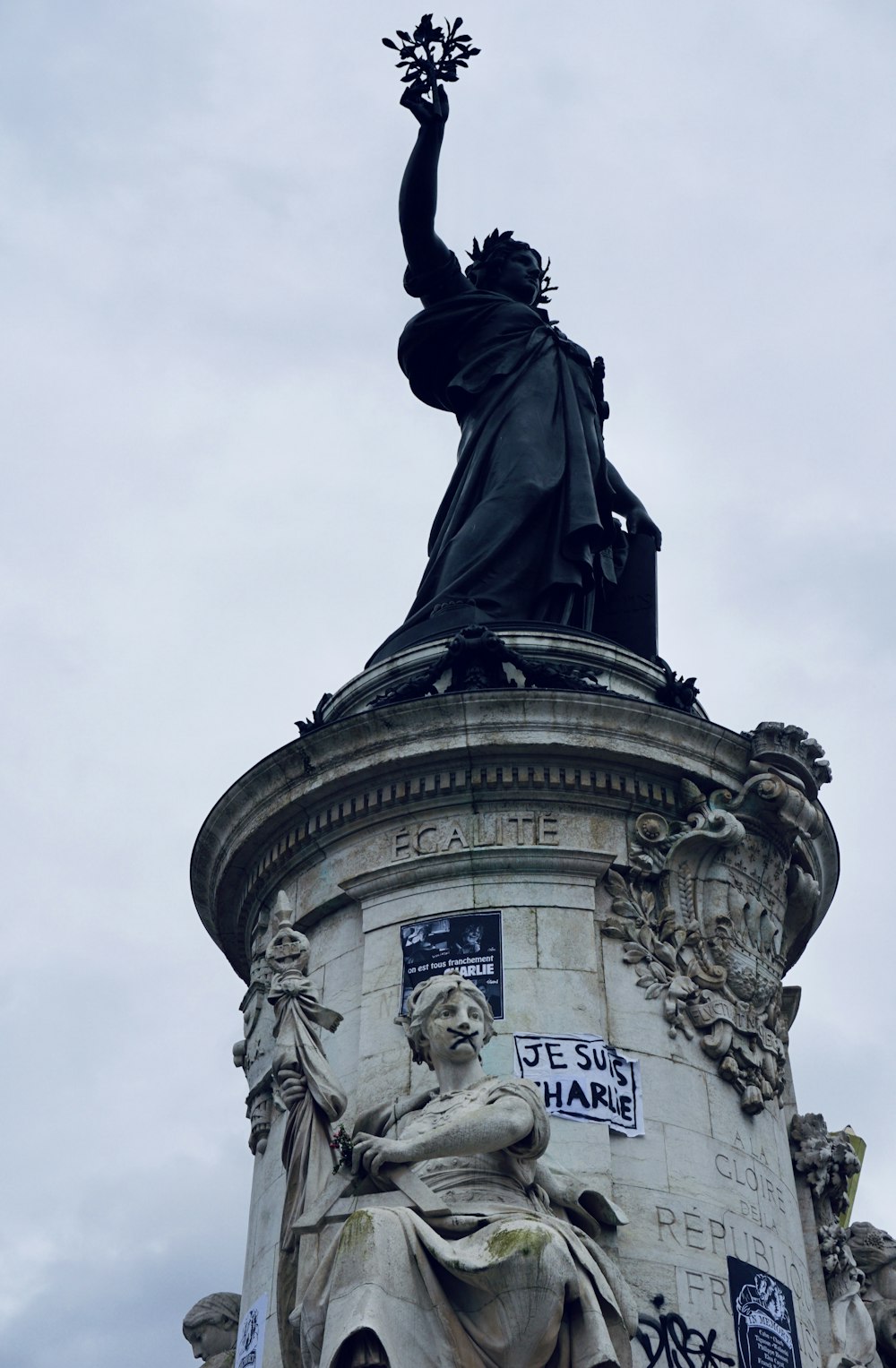 uma estátua de uma mulher que segura um buquê de flores