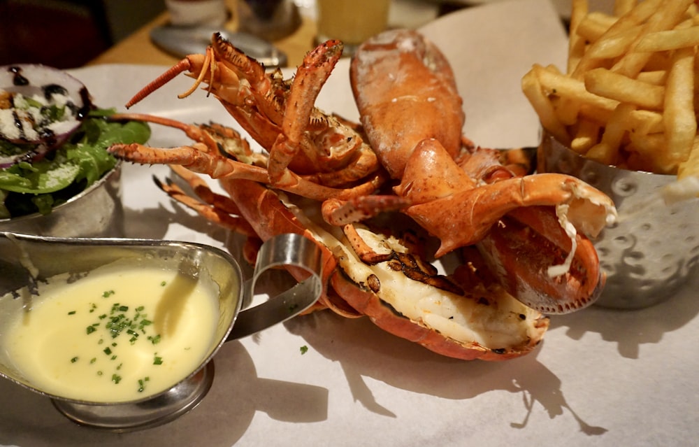 a plate of food with a crab and fries