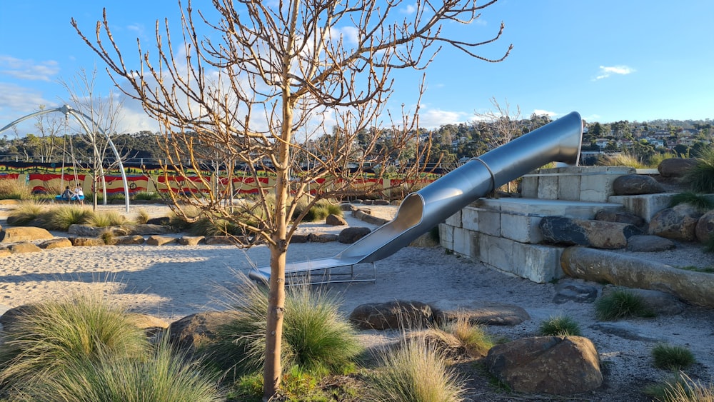 a playground with a slide in the middle of it