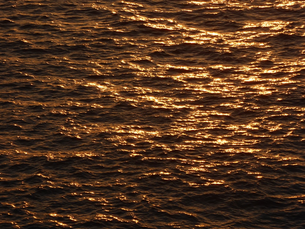 a large body of water with a boat in the distance