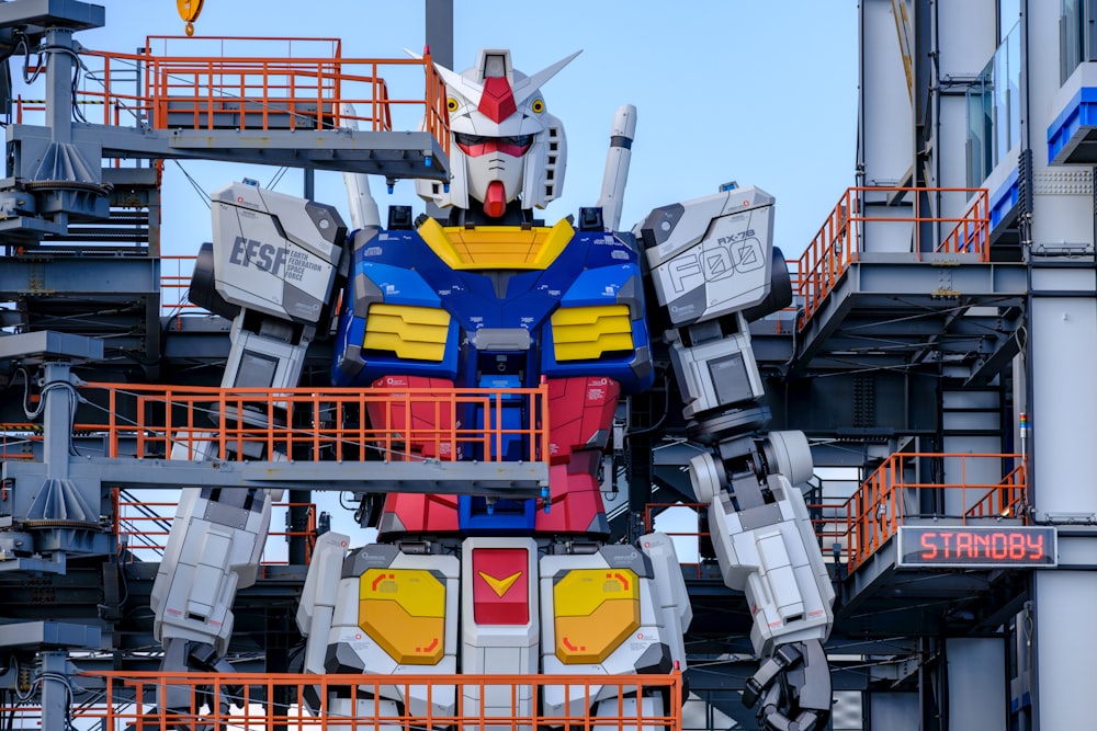 a giant statue of a robot that is standing in front of a building