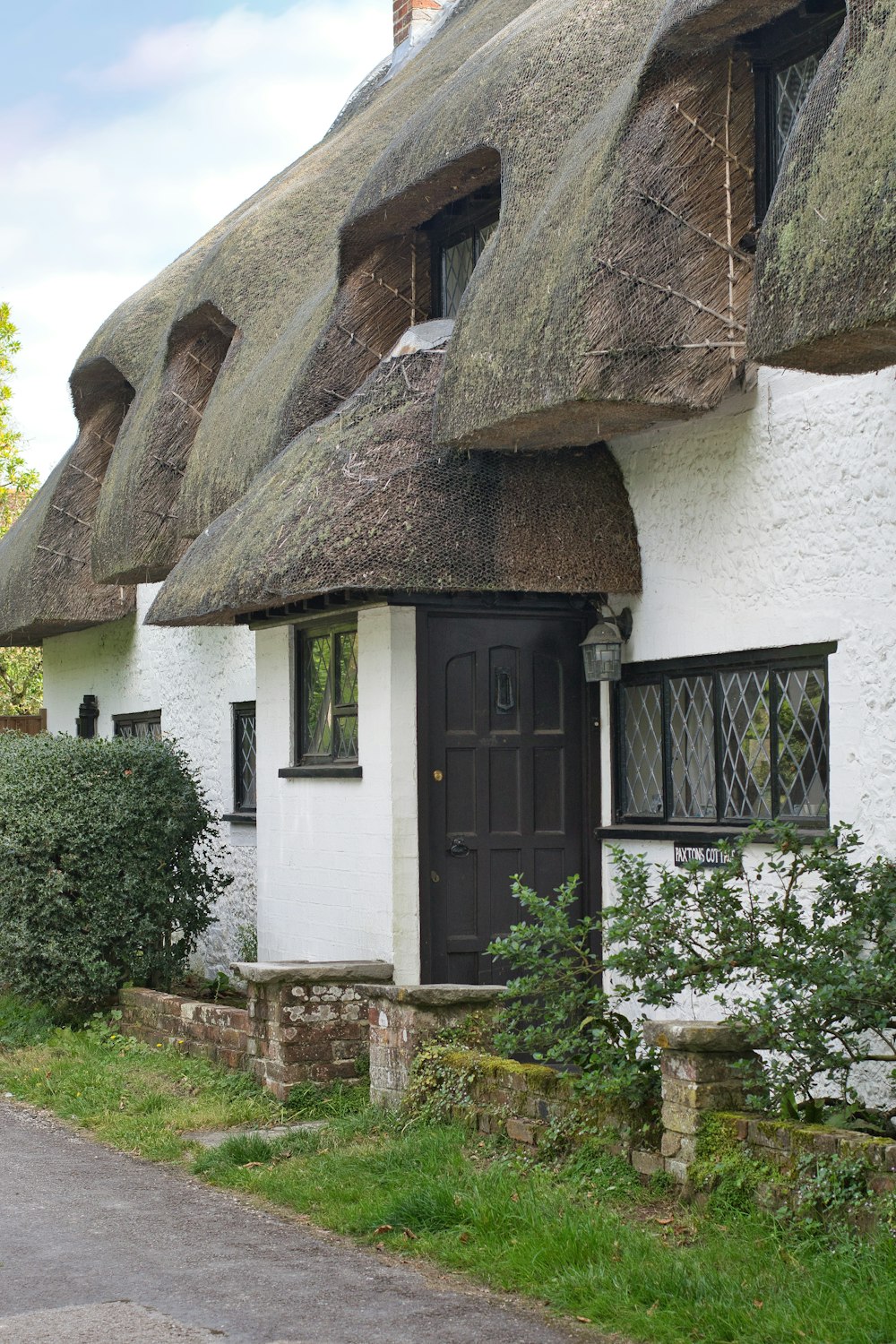 a white house with a black door and windows