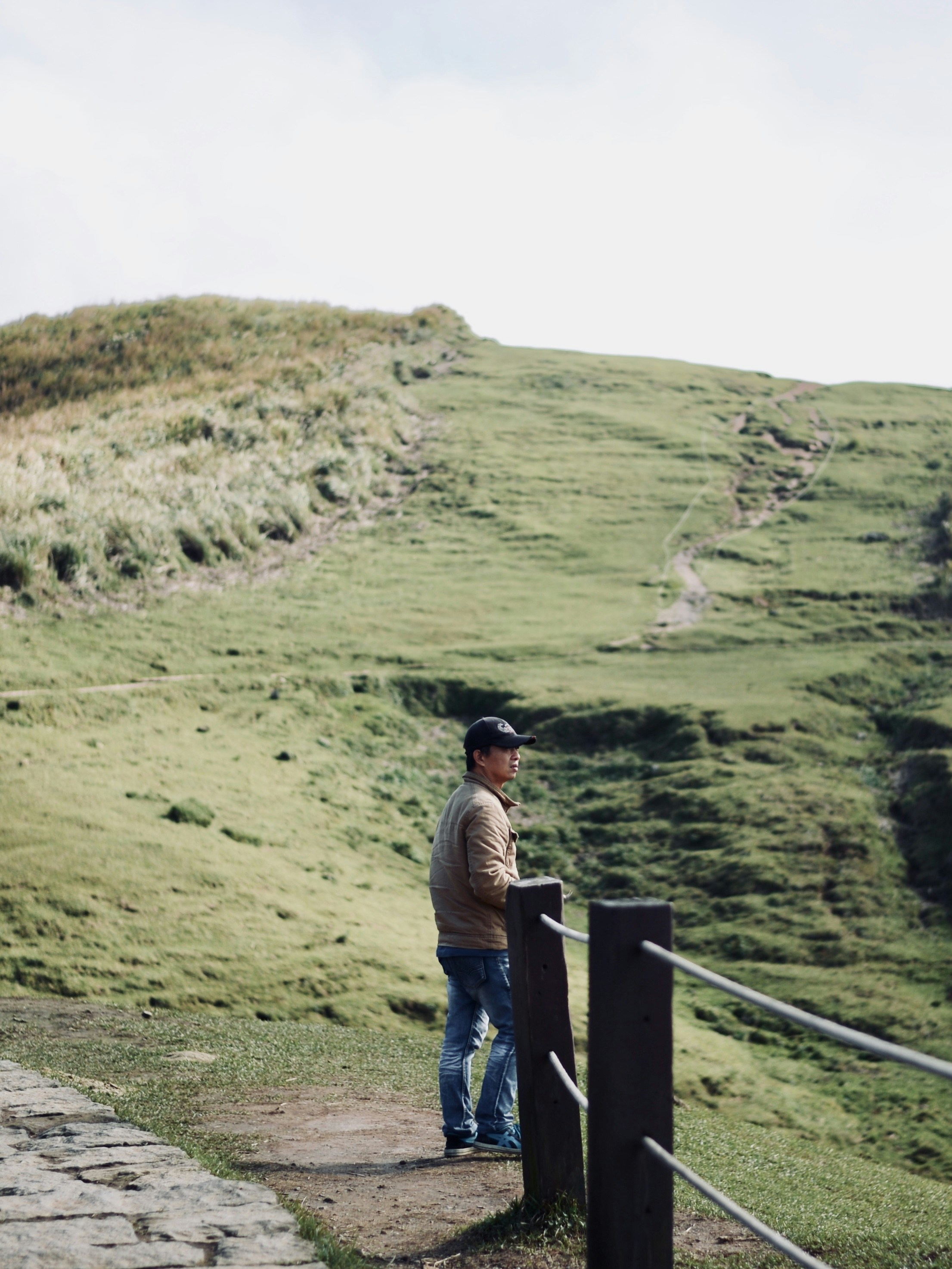 a man standing at the top of a hill