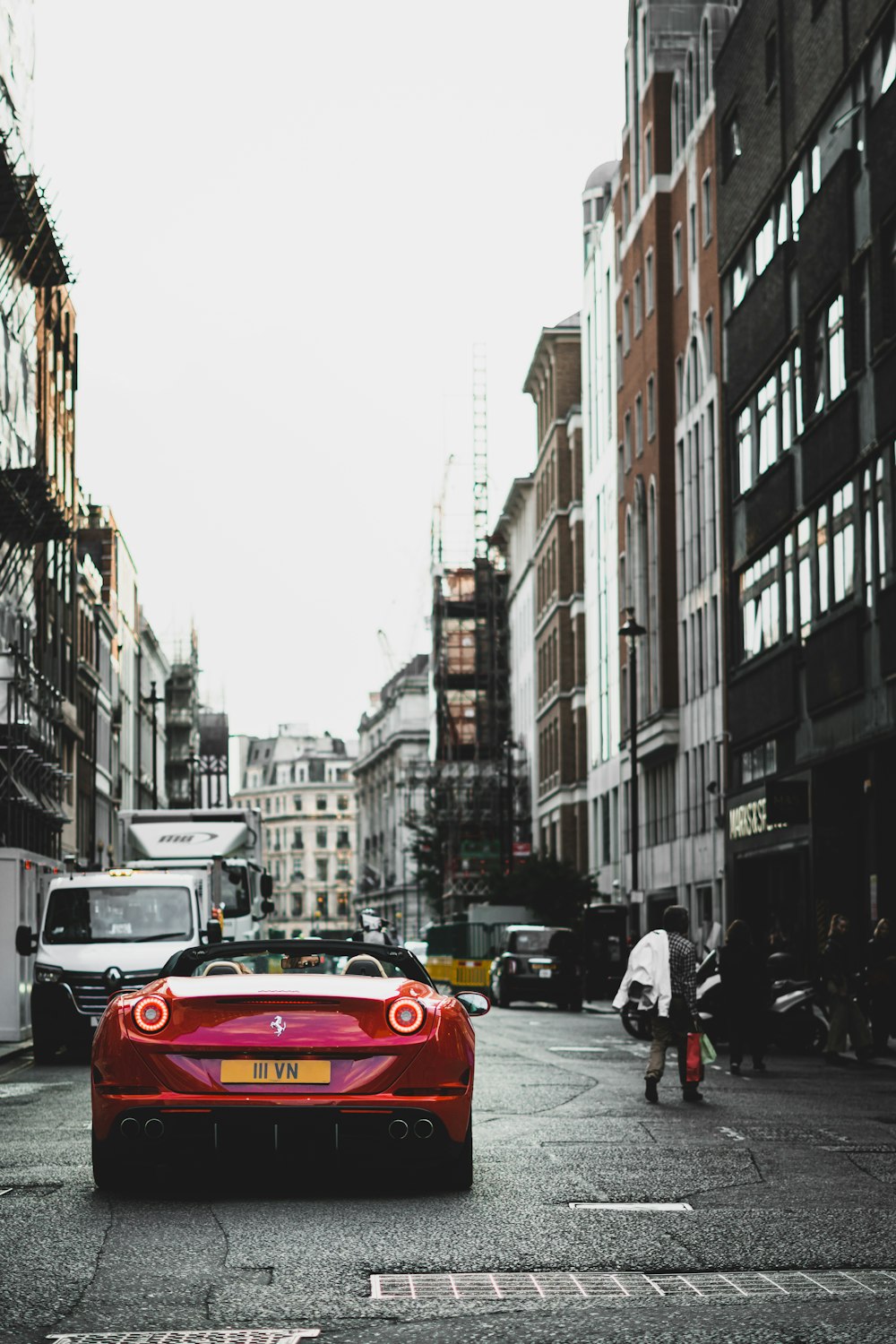 a red sports car parked on a city street