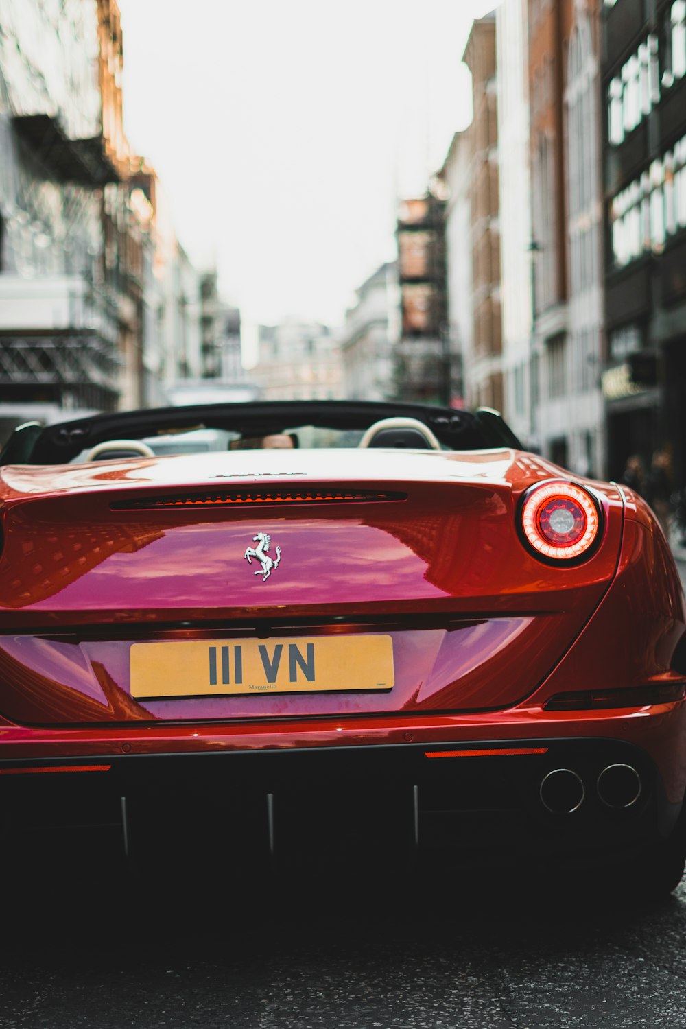 a red sports car parked on the side of the road