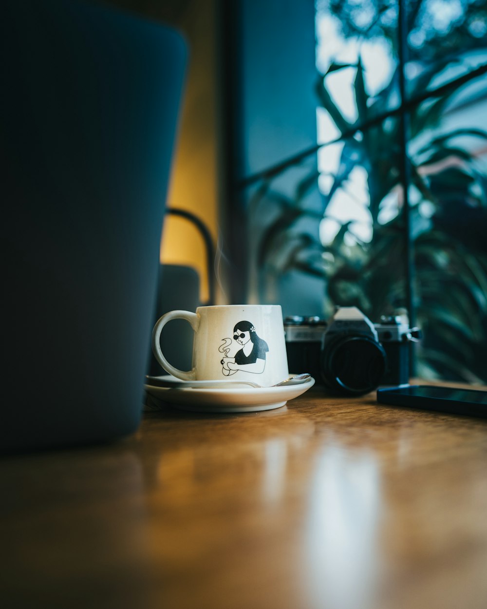 a coffee cup sitting on top of a wooden table