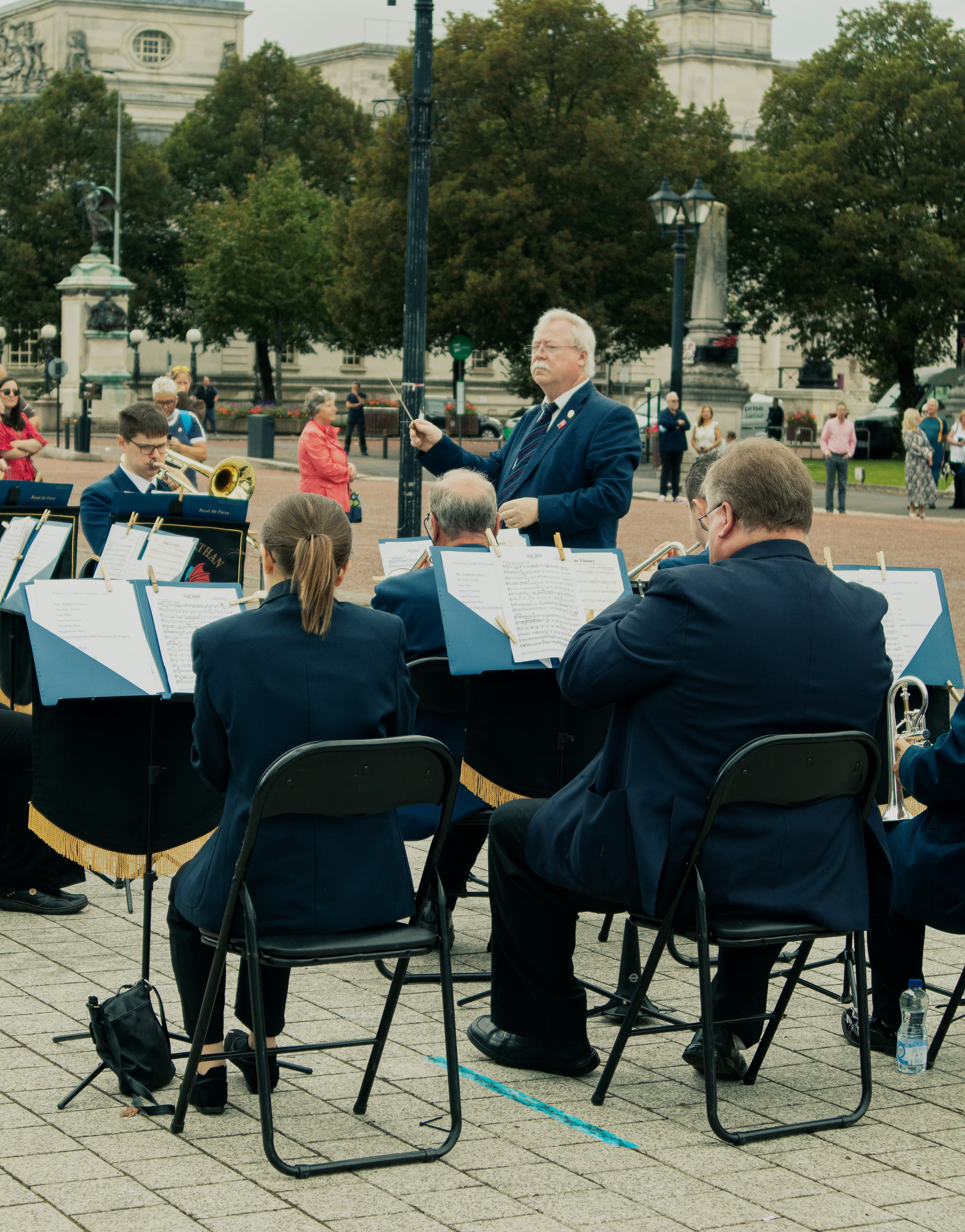 a group of people sitting around a table playing musical instruments