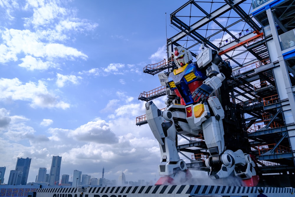 a giant robot sculpture in front of a city skyline