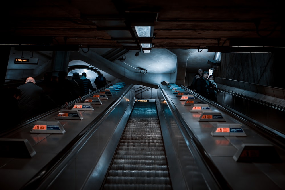 a group of people riding down an escalator