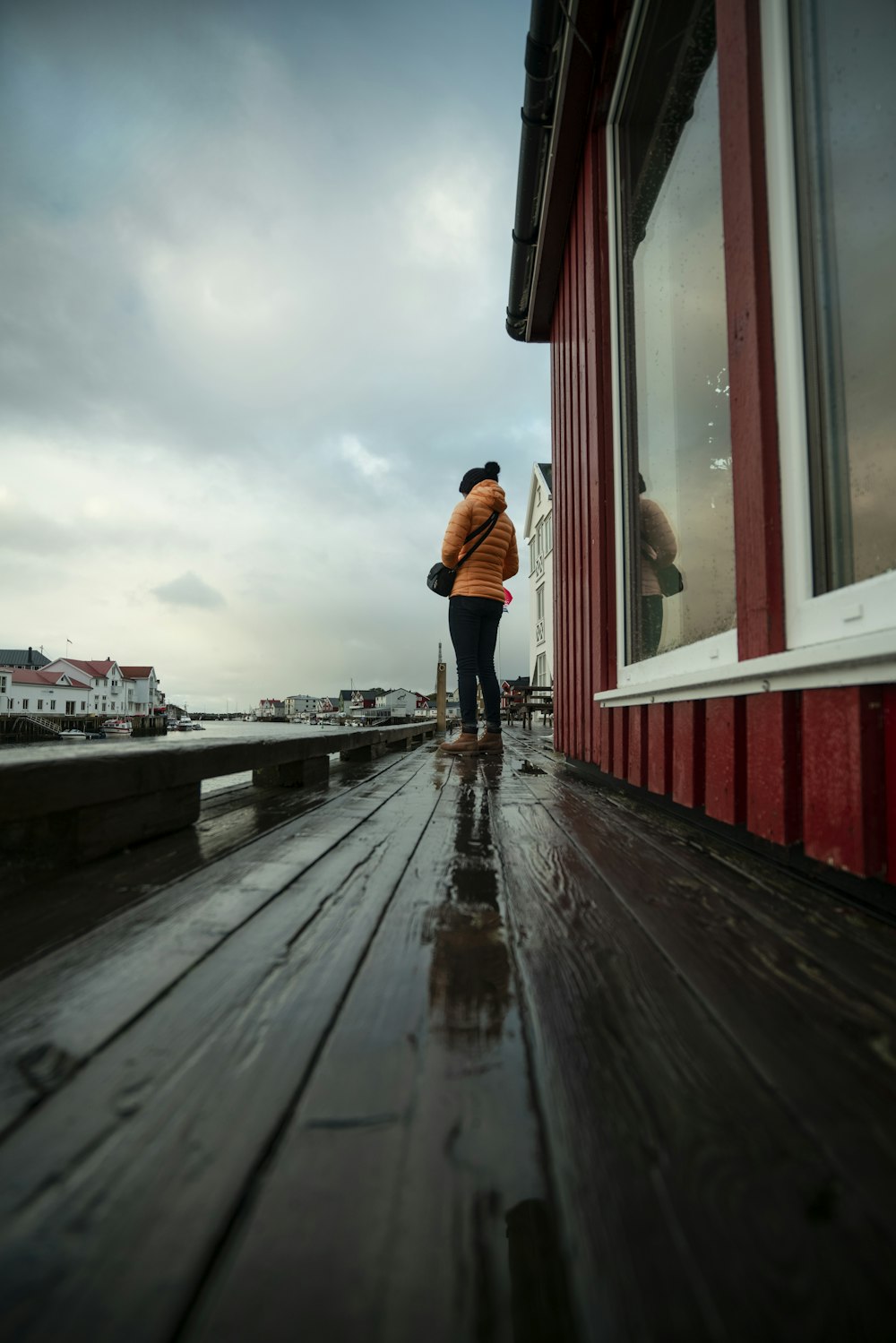 a person standing on a deck next to a building