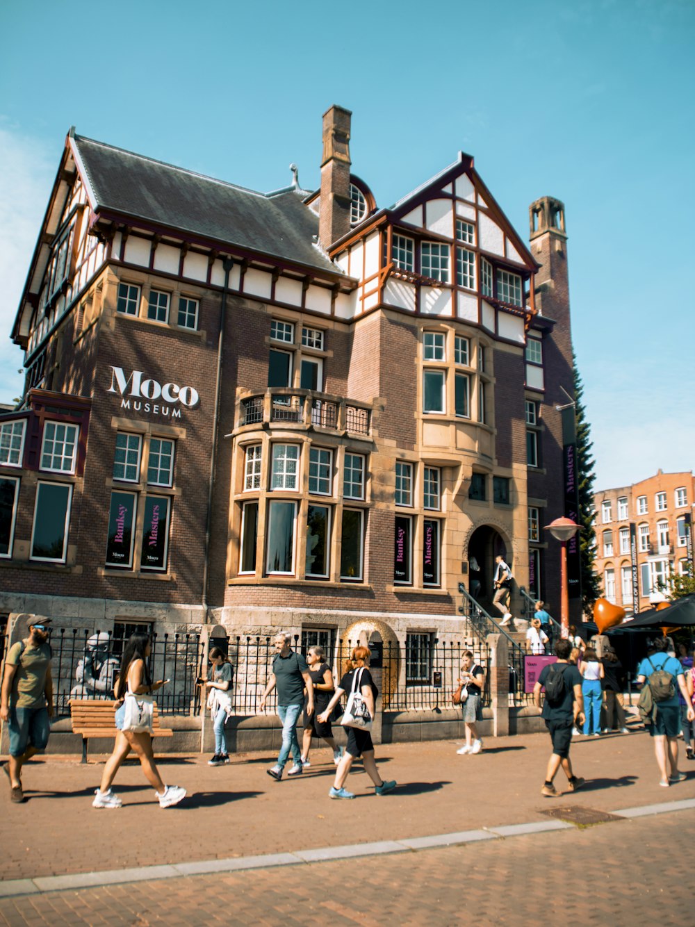 a group of people walking in front of a building