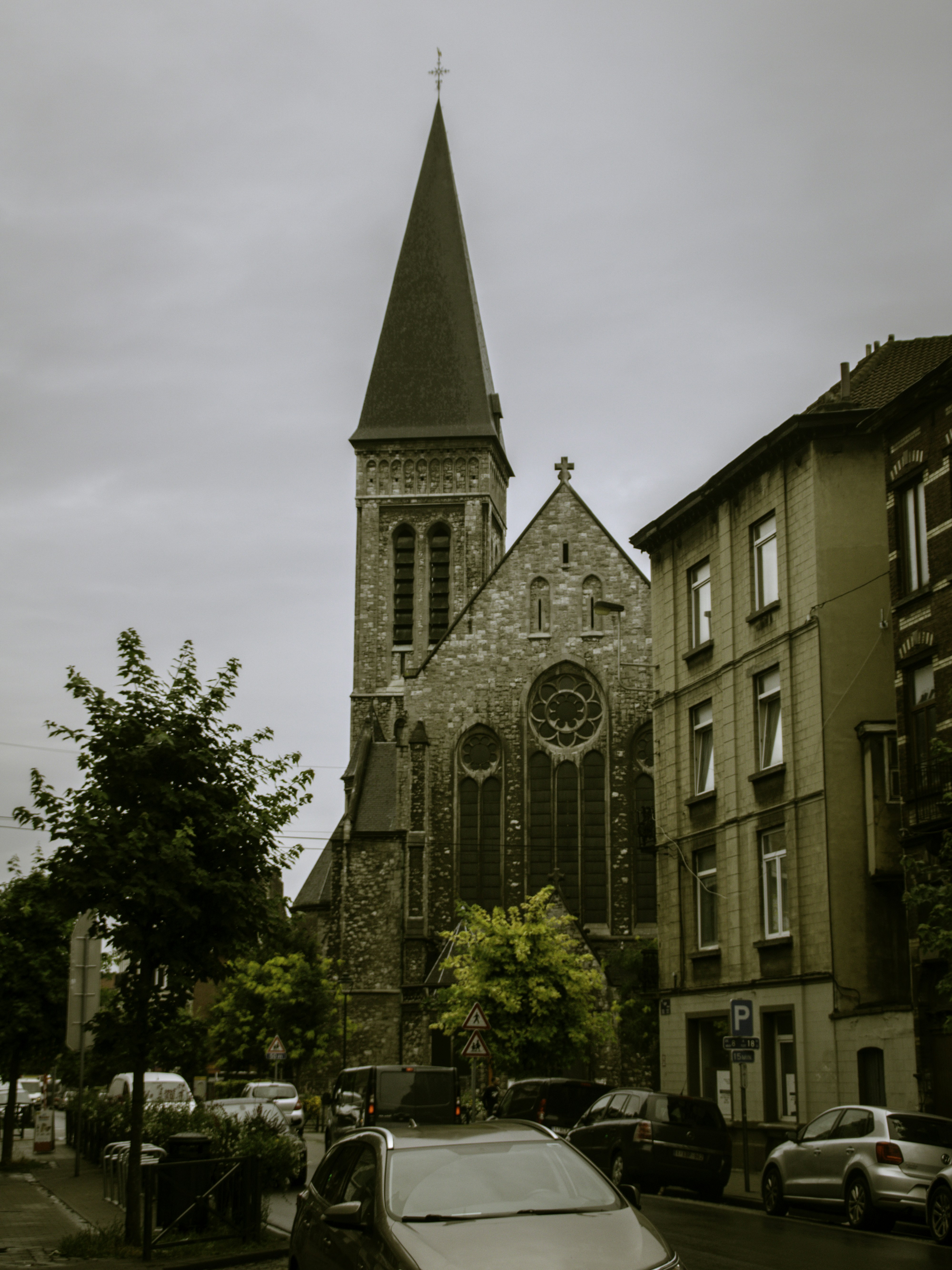a car parked in front of a church with a steeple