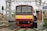 a red and yellow train pulling into a train station