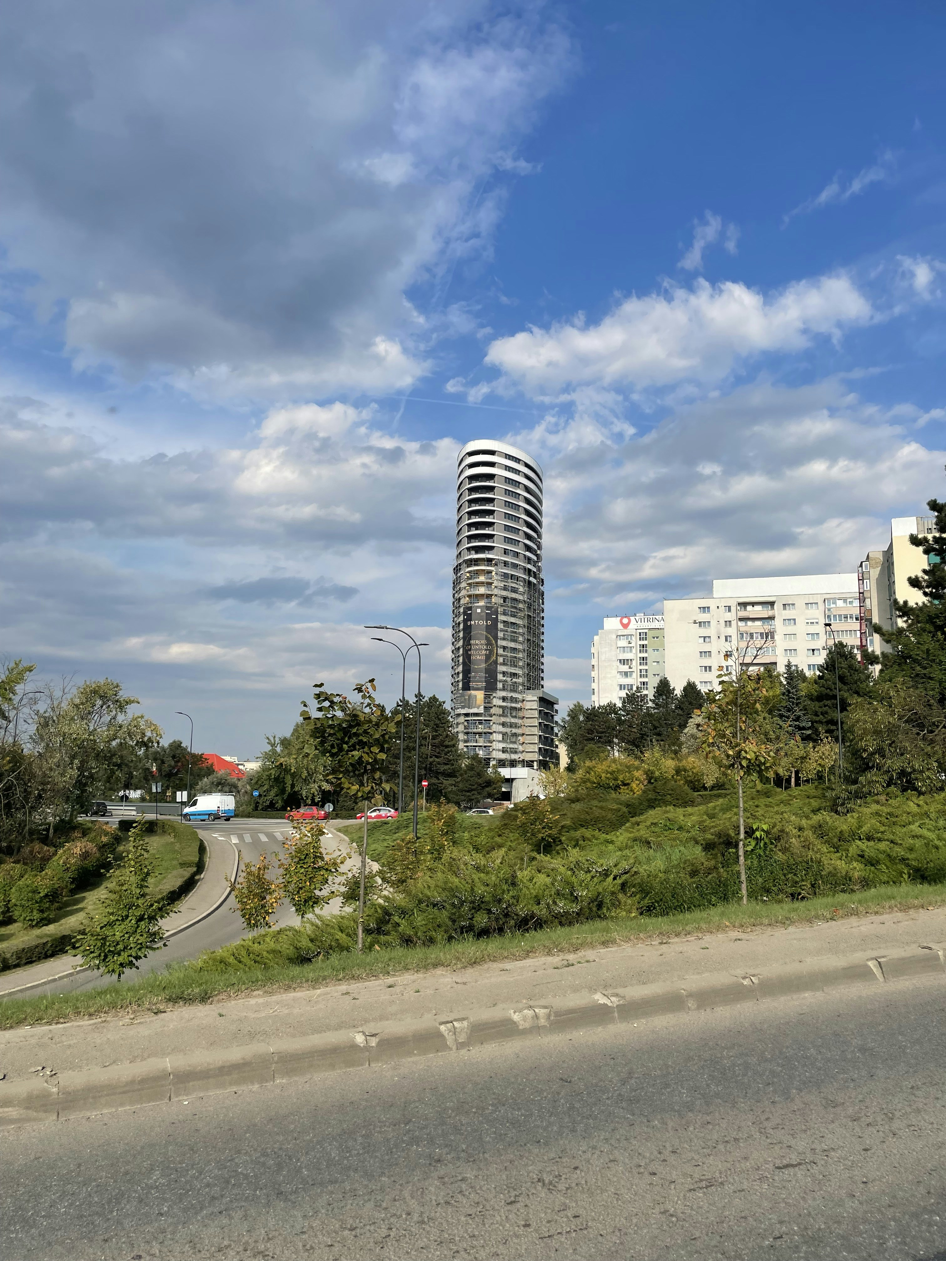 a very tall building sitting on the side of a road